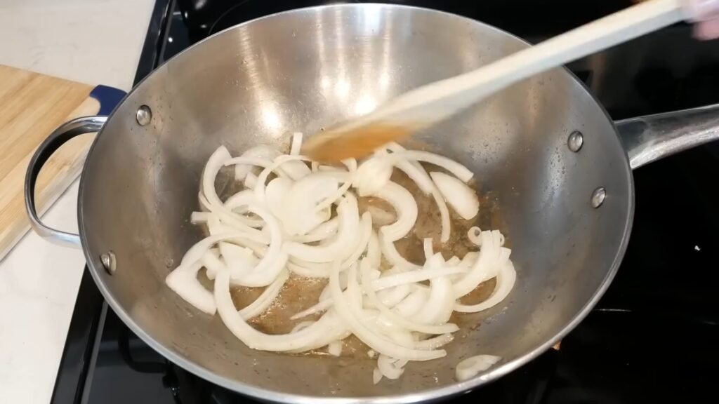 Southern Green Beans with Bacon and Potatoes Cooking onions in bacon grease