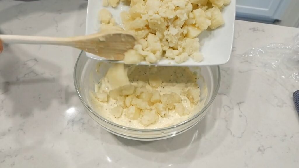 The Best Homemade Potato Salad Adding the potatoes to the dressing
