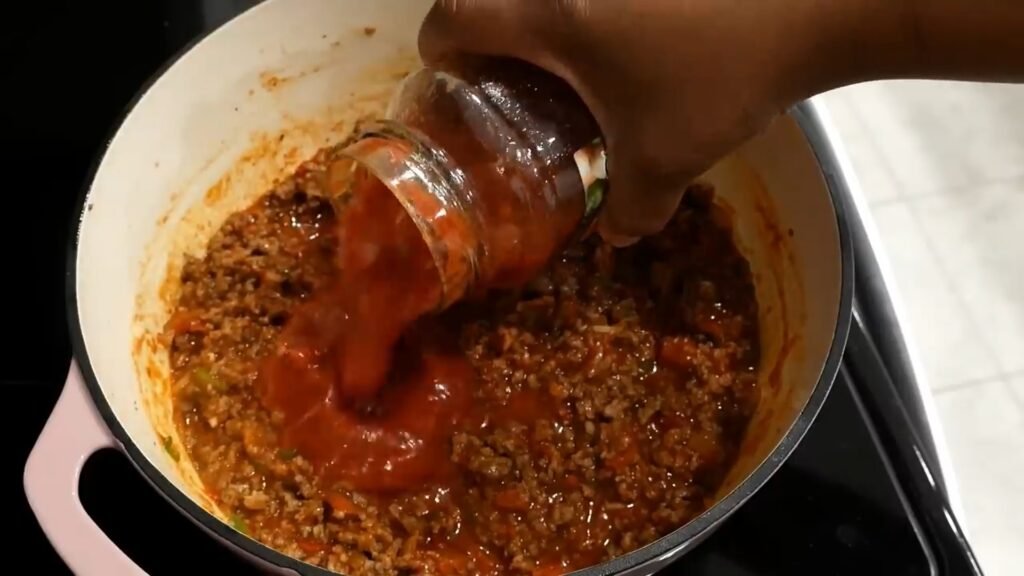 Adding sauce to the meat mixture