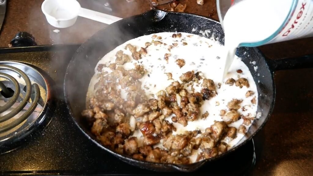 Homemade Sausage Gravy Adding milk to the skillet