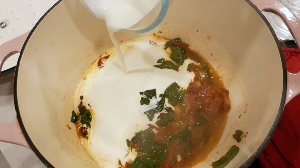 Creamy Tuscan Chicken Adding the heavy cream to the pot