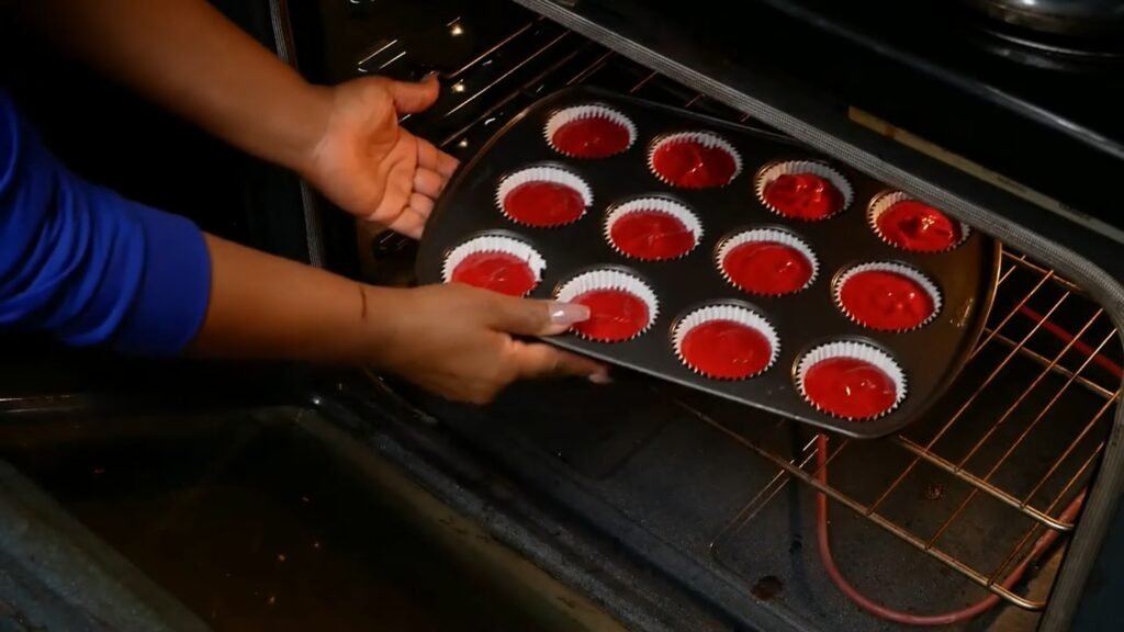 Red Velvet Cupcakes with Cream Cheese Frosting Adding muffins to the oven before baking