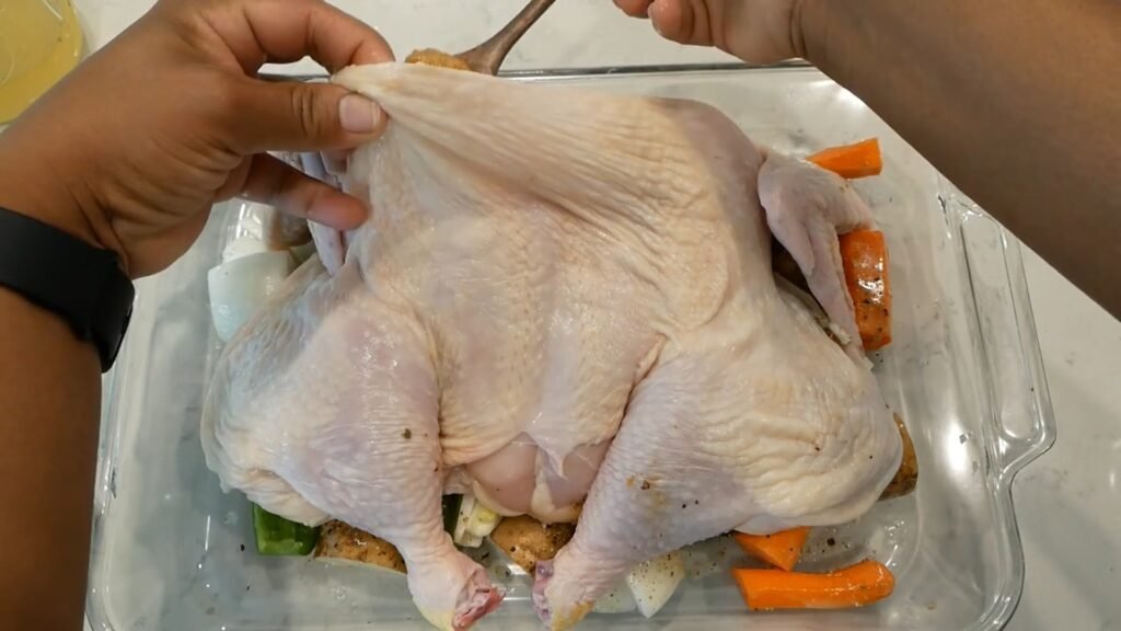 Adding seasoned butter under skin of the chicken