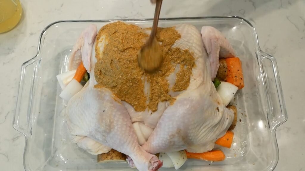 Adding seasoned butter onto the chicken
