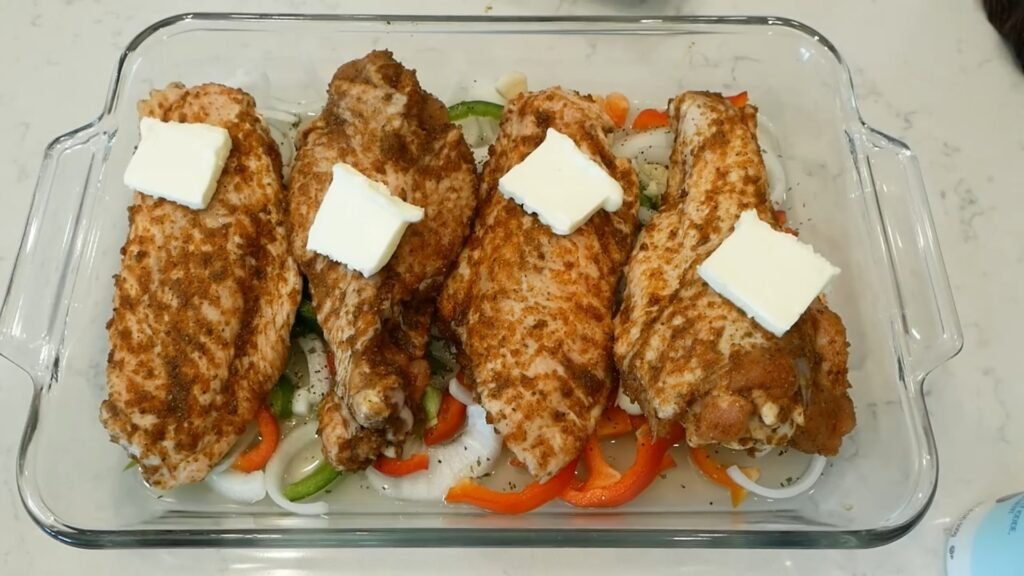 Southern Baked Turkey Wings (Tender & Fall-Off-the-Bone) Seasoned turkey wings arranged over vegetables and chicken broth before slow baking.