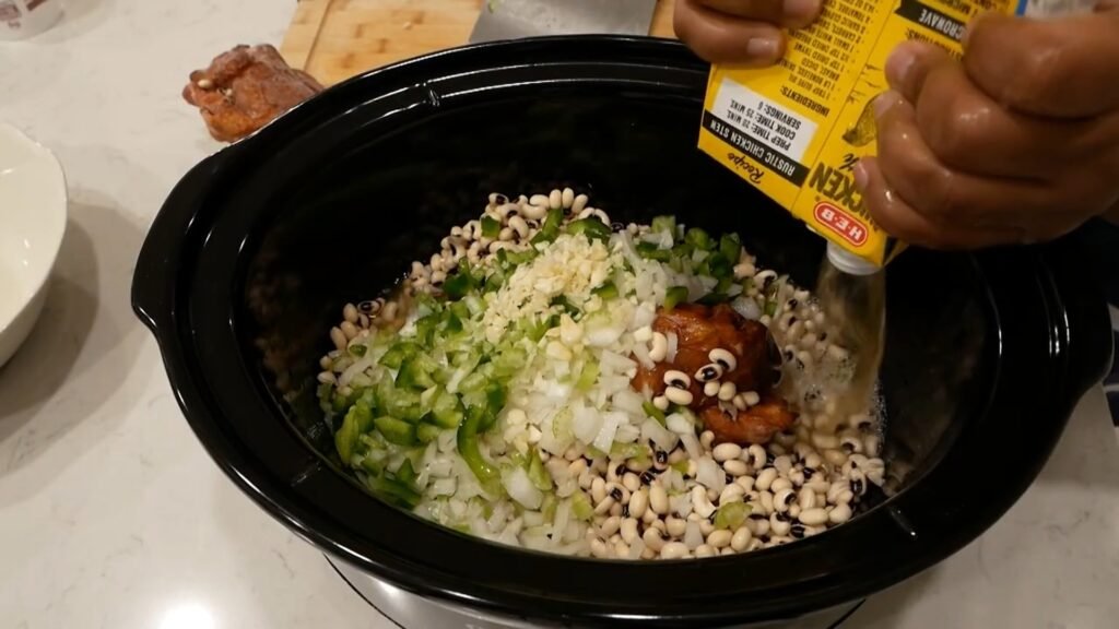 Slow Cooker Black-Eyed Peas Adding broth to the crockpot