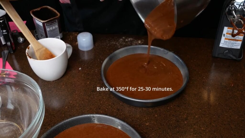 Easy Homemade Chocolate Cake pouring cake batter into cake pans