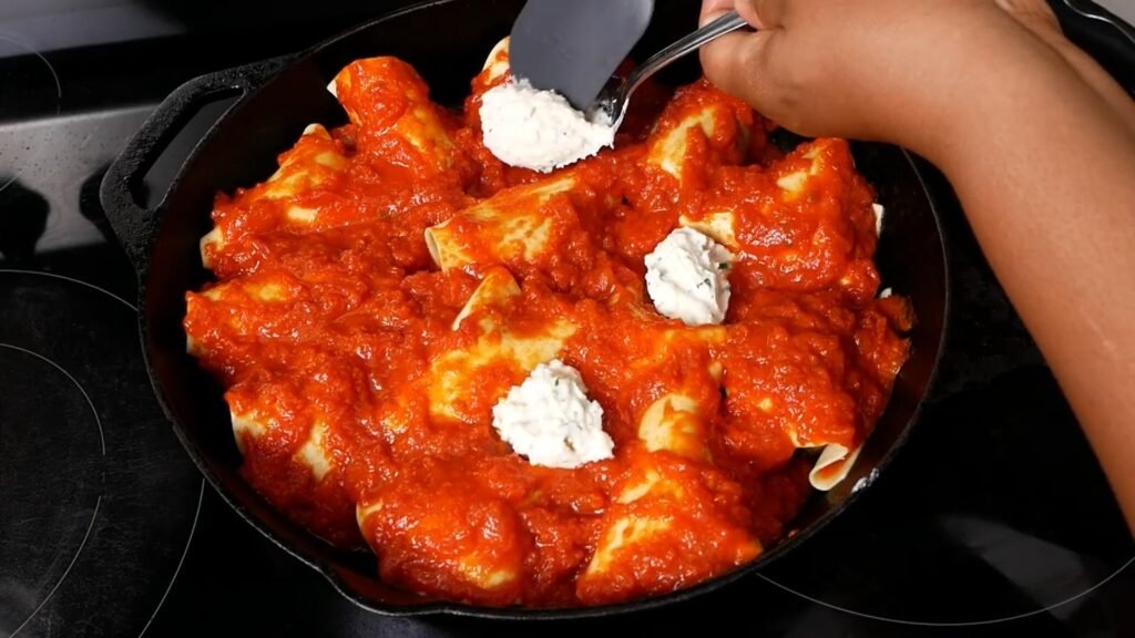 Easy Skillet Meatball Lasagna Spooning in ricotta cheese