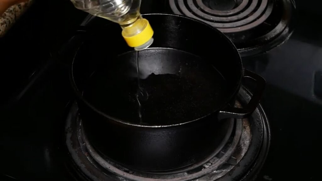 Adding oil to a pot for cooking