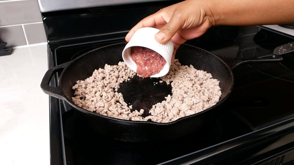 Adding liver to the skillet