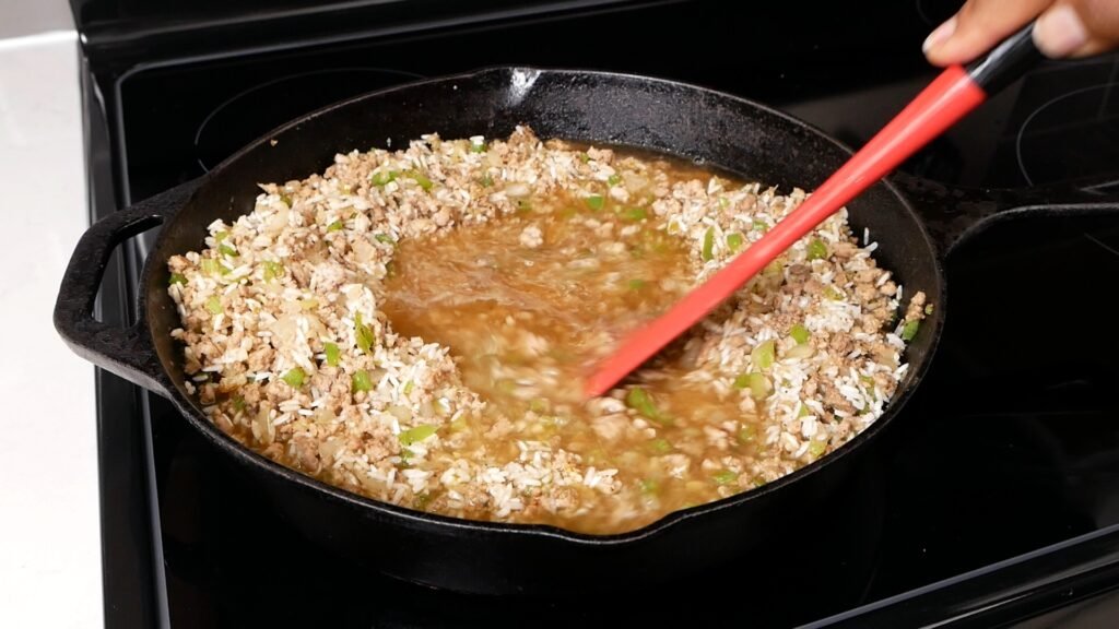 Stirring in the chicken broth